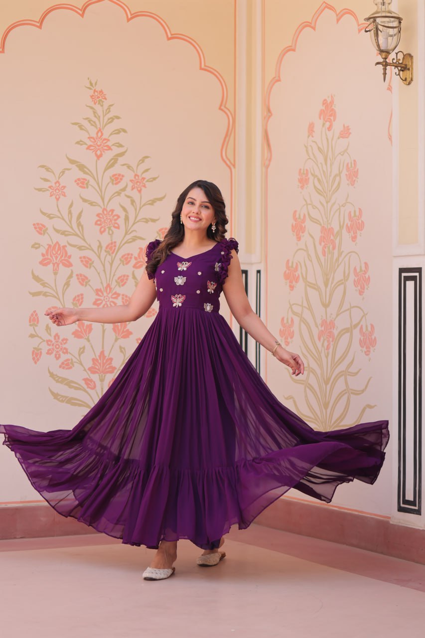 Lavi 7-meter flared designer gown in faux blooming fabric with sequin & bead embroidery, V-neck & frill shoulders – perfect for weddings & parties.